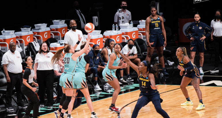 Sabrina Ionescu shoots a three-pointer