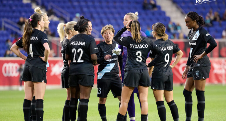 Gotham FC huddles on the field during the 2022 Challenge cup