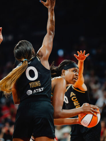NY Liberty center Jonquel Jones tries to score over three Las Vegas Aces players